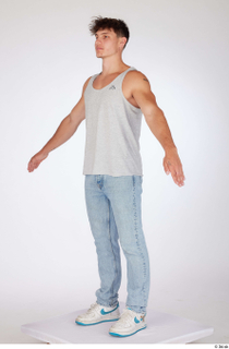 Darren a-poses blue jeans casual dressed grey tank top standing…